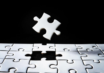 white puzzles arranged on a black background