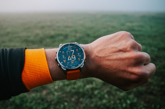 Garmin Watch Garmin Fenix 8, modern Wath 47 mm with amoled display on hand of Trail Runner before the Morning Trail Run
