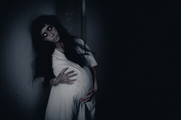 Portrait of asian woman make up pregnant ghost.,Scary horror scene for background,Halloween festival concept,Ghost movies poster