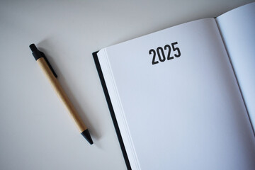 2025 calendar book and pencil on desk