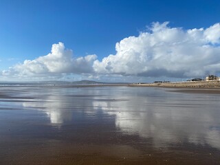 Aberavon beach with clouds reflected in the sand.