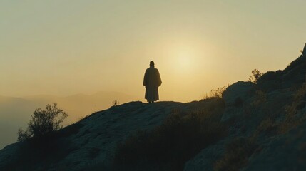 Fototapeta premium Jesus shining in radiant glory on the mountain. A solitary figure walks toward the horizon bathed in golden light.