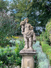 Fototapeta premium Sandstone statues symbolizing the 4 seasons on the territory of Burggarten garden in Rottenburg ob der Tauber, Bavaria, Middle Franconia, Germany