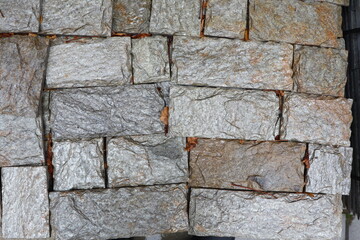 A Textured Stone Wall that Features Varying Shades and Unique Patterns Across Its Surface