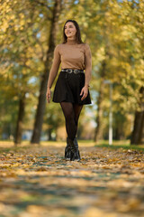 Latin lady in a colorful park in the autumn