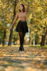 Latin lady in a colorful park in the autumn