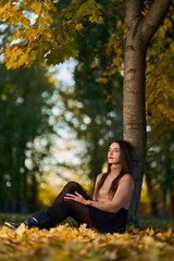 Latin lady in a colorful park in the autumn