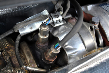 Lambda probe and oxygen sensor diesel engine. Diesel engine turbine close up. Diesel engine parts...