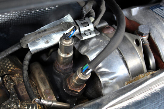Lambda probe and oxygen sensor diesel engine. Diesel engine turbine close up. Diesel engine parts close up.