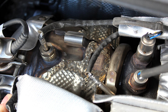 Diesel engine turbine. Сlose up engine turbine. Diesel Engine parts. Fragment diesel motor. Engine lambda probe. Oxygen sensor.