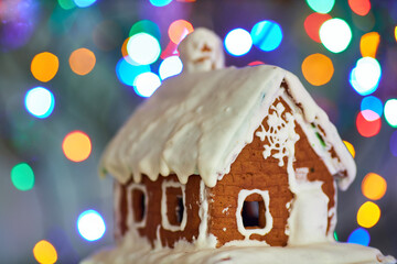 Close up of drawing gingerbread Christmas snowflake sugar cookie on wooden table background with white icing