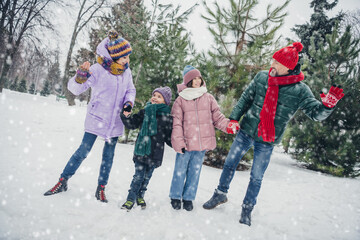 Photo of cute positive little child wife husband dressed coats waving holding arms walking outdoors urban forest park
