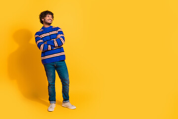 Full size photo of pretty young male crossed hands look empty space wear trendy blue striped outfit isolated on yellow color background