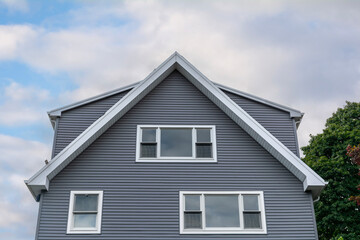 Elegant gray family home with white trim and gable roof in Boston, Massachusetts, USA