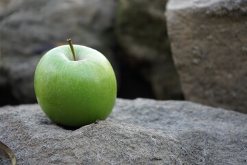 green apple lying on the stones