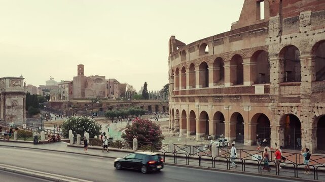 Arch of Constantine nearby summer Traffic and pedestrians fill foreground, showcasing blend ancient history modern city life. Tourism concept. Travel