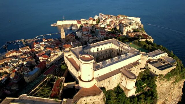 Italy Lazio Gaeta Aerial 4K Drone Video Sunset Over Medieval Aragonese Castle on Vertical Rocky Cliff Peninsula Scenic Old Town Panoramic View Mediterranean Sea cinematic footage
