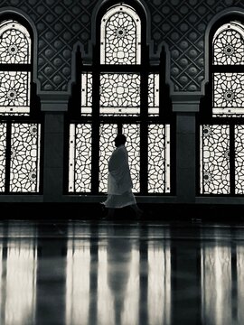 A silhouette photo of a man in the middle of the Safa and Marwa in the harram
