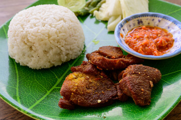 Nasi Empal Penyet Indonesian Deep Fried Beef Slices Served with Steamed Rice and Sambal Chili Sauce