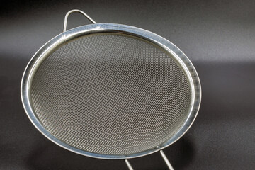 Metallic colander for cooking closeup.