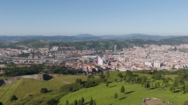 Aerial footage of Mount Cobetas with a view over Bilbao city on a sunny day in Biscay, Spain