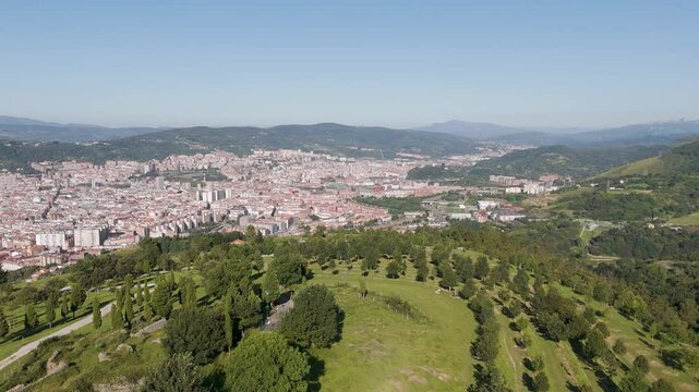 Aerial footage of Mount Cobetas with the cityscape of Bilbao in the background in Biscay, Spain