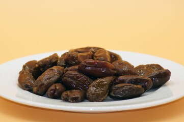 Dried Dates Isolated on an Orange Background.