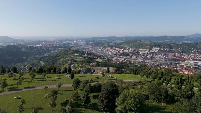 Drone footage of the green Mount Cobetas in Bilbao city on a sunny day in Biscay province, Spain