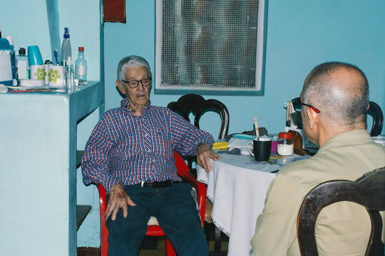 Elderly man having a conversation with his son