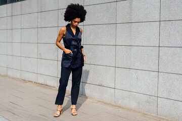 Elegant Woman Standing in Urban Landscape