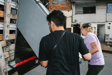 moving: loading refrigerator onto moving truck