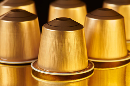 Gold Coffee Pods on Gold Surface 