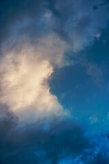 Dramatic cloud formations illuminated by soft light during the early evening in a tranquil sky