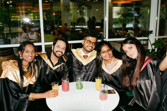 Indian students wearing graduated uniform  celebrating graduation.