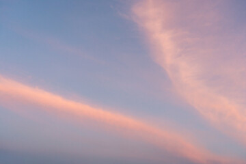 Soft Pastel Clouds Against Blue Sky At Dusk