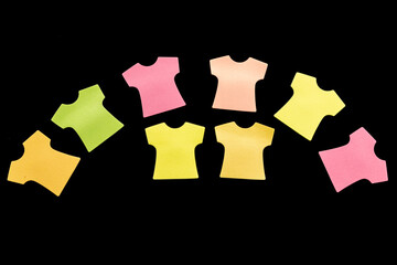 Eight blank sticky note pads in the shape of T-shirts, arranged in an arc with colors in salmon,...