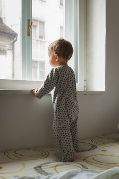 Little boy looking out the window