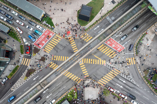 A busy city street with a crosswalk and a red and white