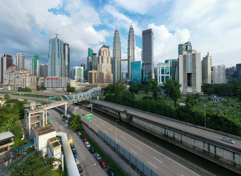 A city with a lot of tall buildings and a bridge