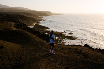 Sporty man admires the coastal scenery of Timanfaya National Park