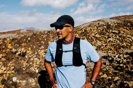 Runner takes a break during trail running session on rugged paths