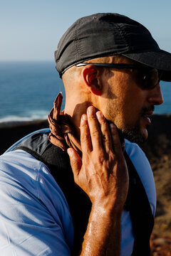 Athlete uses a hand to check his pulse after a hiking training session