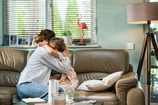 Mom hugs a sick child