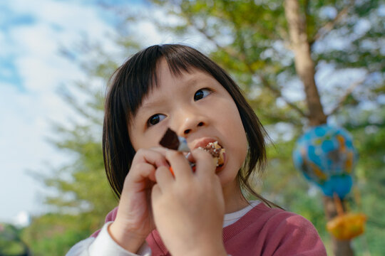 Portrait of little girl eating chocolate
