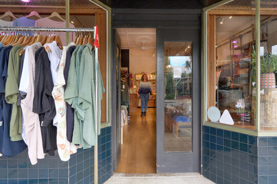 A shopper browses a boutique of colorful clothes and accessories