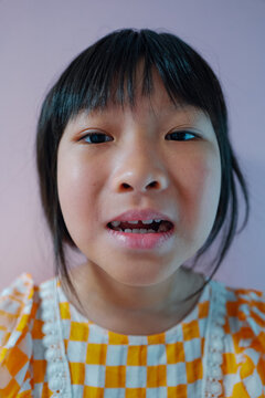Real life of Asian girl has a tooth falling out