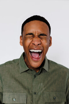 Man screaming with closed eyes and open mouth