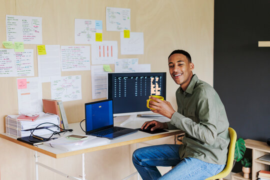 Developer working from home and smiling at camera