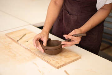 Hands of a Woman making a Vase of Clay
