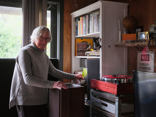 Elderly transgender woman choosing a record to play